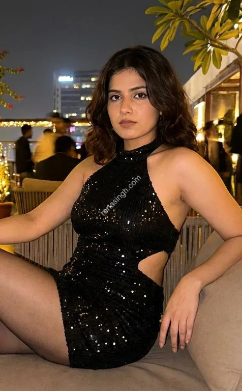 Isha in sequin dress rooftop